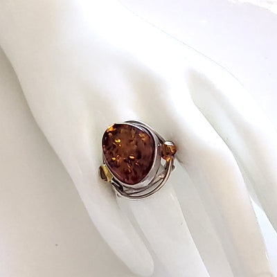 Oval natural amber large ring with beads in sterling silver on display