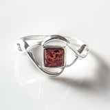 celtic sterling silver ring with a square amber in the center of the ring 