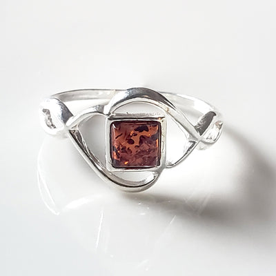celtic sterling silver ring with a square amber in the center of the ring 