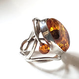  amber ring with small amber beads on each side of the main stone. 
