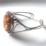 side of cuff silver bracelet with honey amber