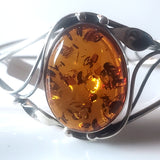 oval honey amber large stone in a silver frame