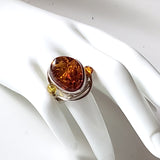 Large Oval Amber Silver Ring with Amber Beads on display 
