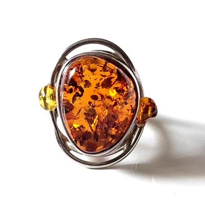 Large Oval Amber Silver Ring with 2  Amber Beads on both sides of the silver ring frame