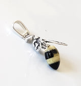 Tiny silver pendant with natural amber tail