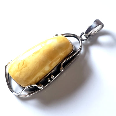 one of the king butterscotch oval amber pendant in sterling silver frame