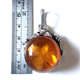 size of the Classic Round Natural amber pendant in sterling silver frame