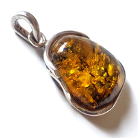 Green freeform amber pendant in sterling silver wire frame 