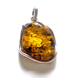 Green freeform amber pendant in sterling silver wire frame 