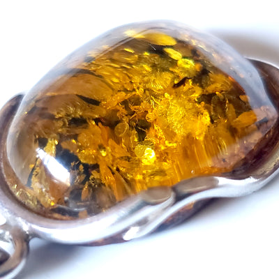 Green freeform amber pendant in sterling silver wire frame 