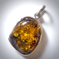 Green freeform amber pendant in sterling silver wire frame 