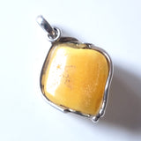 back of genuine light yellow  butterscotch amber pendant in sterling silver frame
