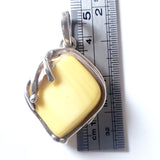 size of genuine light yellow  butterscotch amber pendant in sterling silver frame