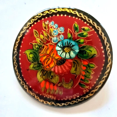 Red brooch with small flowers