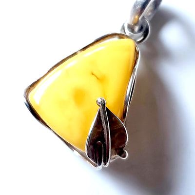 Classic small butterscotch amber pendant in sterling silver frame with a leaf