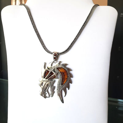 silver dragon pendant with amber