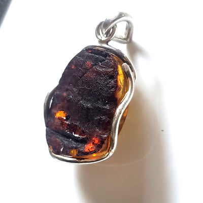 back of Green freeform amber pendant in sterling silver wire frame 