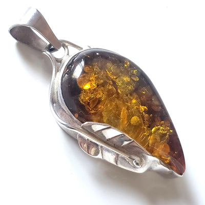 Large golden-green natural amber pendant with leaves