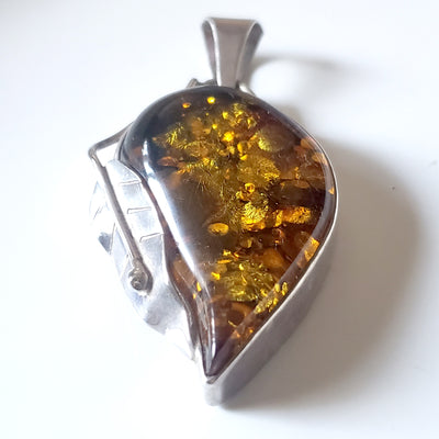 Large golden-green natural amber pendant