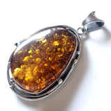 Large green amber in sterling silver pendant