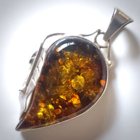 Large golden-green natural amber pendant