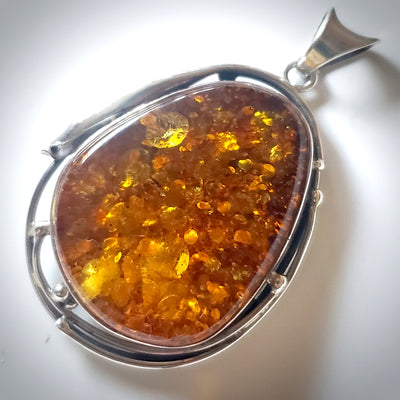 Large green amber in sterling silver pendant