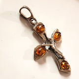 silver cross pendant with amber