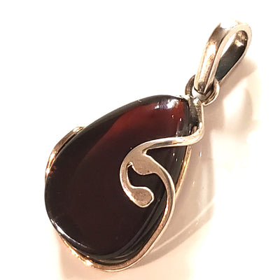 cherry red amber in modern silver setting