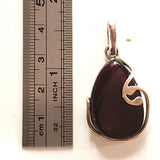 cherry amber pendant in modern sterling silver frame