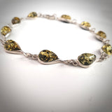 small silver bracelet with green amber beads