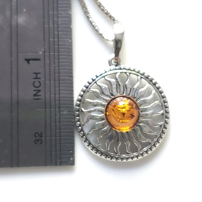 silver sun necklace in box 